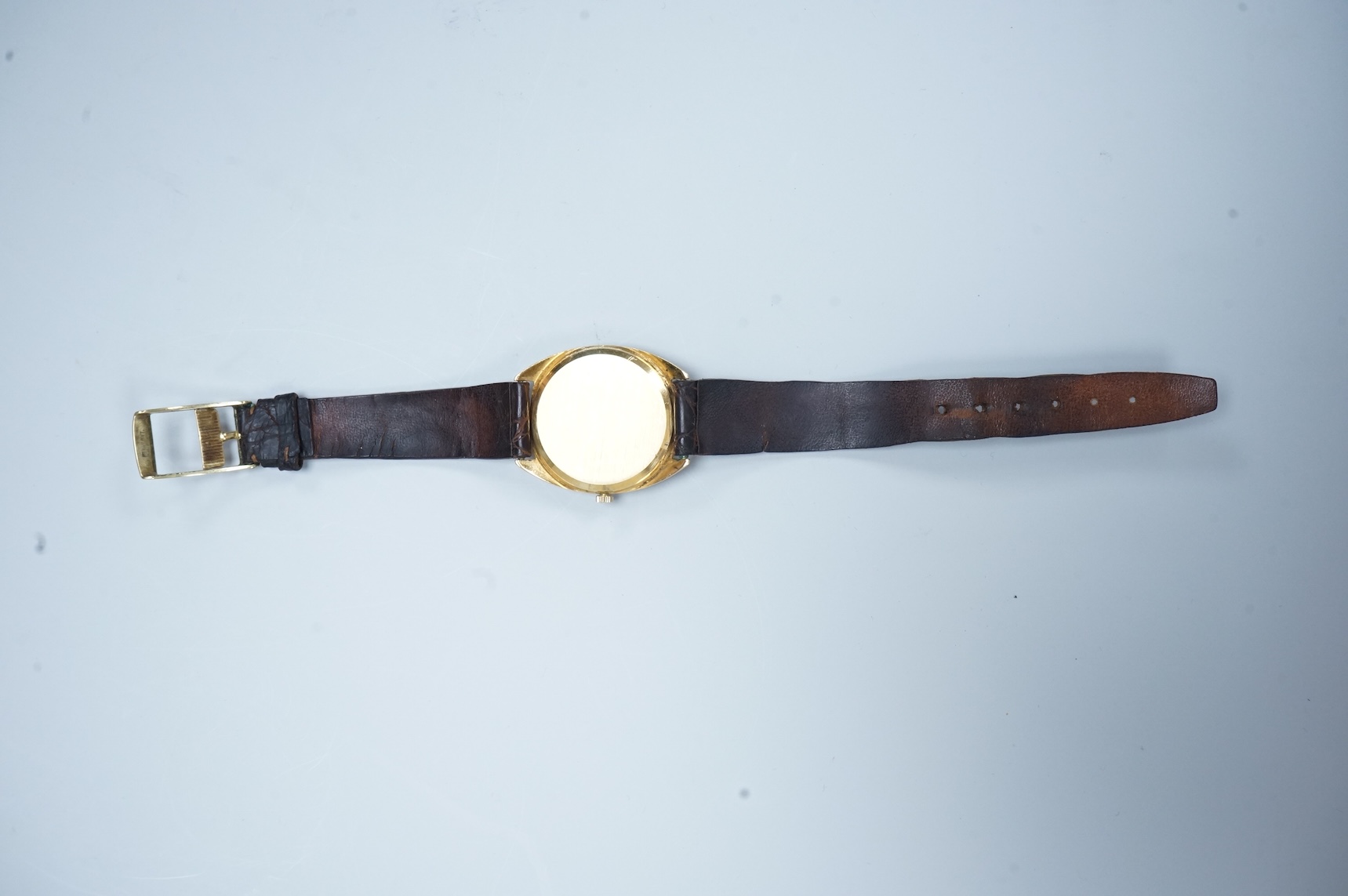A gentleman's early 1970's 18ct gold Omega manual wind wrist watch, with baton numerals, case diameter 35mm, movement c.601, on a leather strap with gold plated buckle, no box or papers.